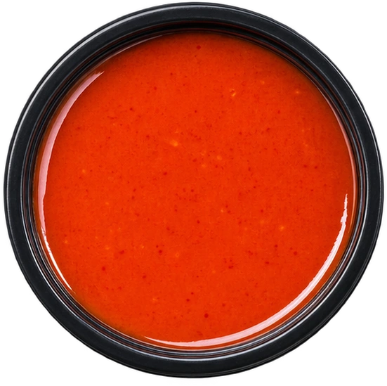 Bird’s-eye view of FRANK’S sauce in a dipping pot