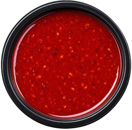 Overhead pot of deep red chilli sauce
